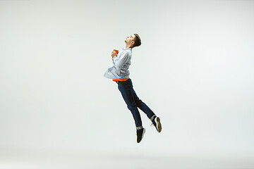 Image showing Man working at office and jumping isolated on studio background