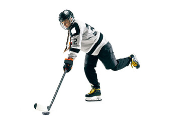 Image showing Young female hockey player with the stick isolated on white background