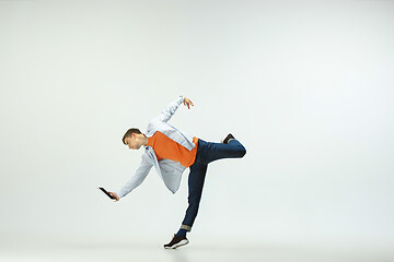 Image showing Man working at office and jumping isolated on studio background