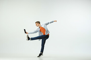 Image showing Man working at office and jumping isolated on studio background