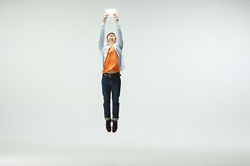 Image showing Man working at office and jumping isolated on studio background