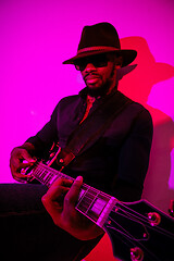 Image showing Young african-american jazz musician playing the guitar