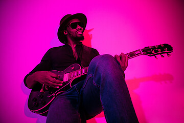 Image showing Young african-american jazz musician playing the guitar