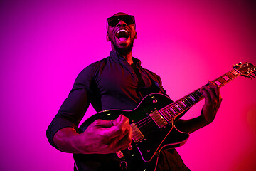 Image showing Young african-american jazz musician playing the guitar