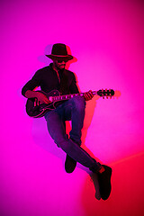 Image showing Young african-american jazz musician playing the guitar