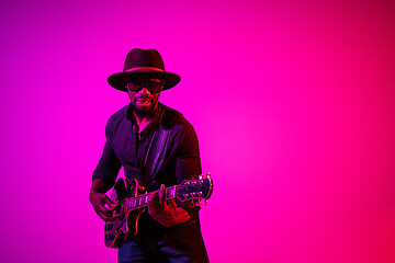 Image showing Young african-american jazz musician playing the guitar