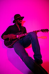 Image showing Young african-american jazz musician playing the guitar