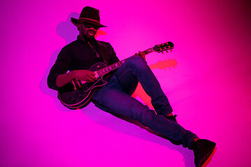 Image showing Young african-american jazz musician playing the guitar