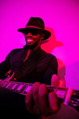 Image showing Young african-american jazz musician playing the guitar