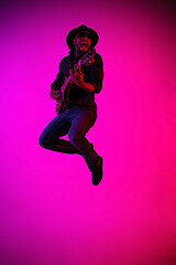 Image showing Young african-american jazz musician playing the guitar