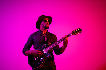 Image showing Young african-american jazz musician playing the guitar