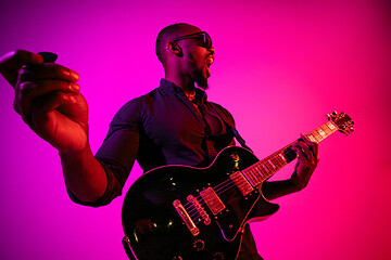 Image showing Young african-american jazz musician playing the guitar