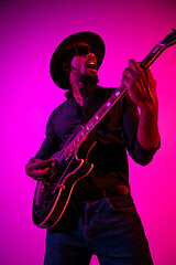 Image showing Young african-american jazz musician playing the guitar