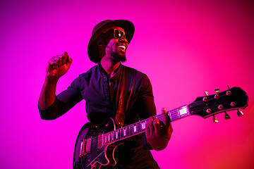 Image showing Young african-american jazz musician playing the guitar