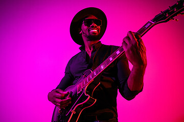 Image showing Young african-american jazz musician playing the guitar