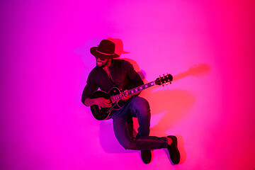 Image showing Young african-american jazz musician playing the guitar