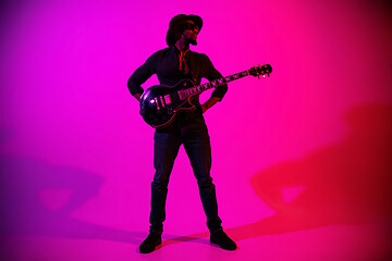 Image showing Young african-american jazz musician playing the guitar