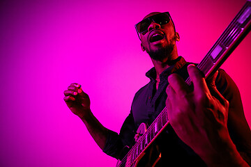 Image showing Young african-american jazz musician playing the guitar