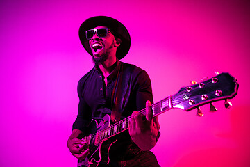 Image showing Young african-american jazz musician playing the guitar