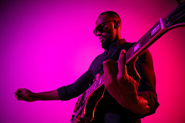 Image showing Young african-american jazz musician playing the guitar