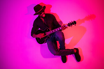 Image showing Young african-american jazz musician playing the guitar