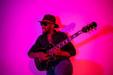 Image showing Young african-american jazz musician playing the guitar