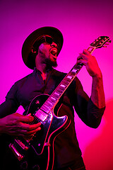 Image showing Young african-american jazz musician playing the guitar