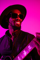 Image showing Young african-american jazz musician playing the guitar