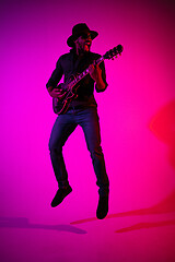 Image showing Young african-american jazz musician playing the guitar