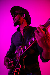 Image showing Young african-american jazz musician playing the guitar