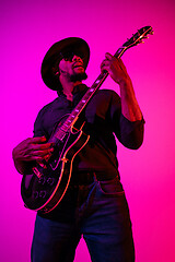 Image showing Young african-american jazz musician playing the guitar