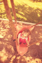 Image showing little girl swinging  on a playground