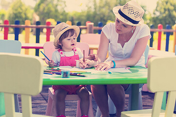 Image showing mom and little daughter drawing a colorful pictures