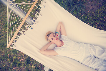 Image showing young woman resting on hammock