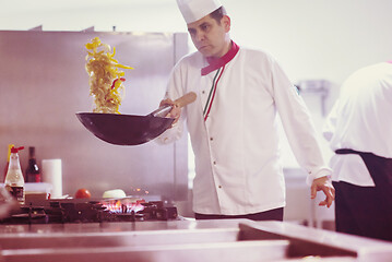 Image showing chef flipping vegetables in wok