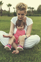 Image showing mother and little daughter playing at backyard