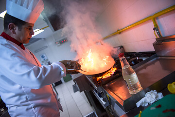 Image showing Chef doing flambe on food