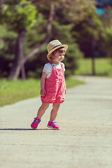 Image showing little girl runing in the summer Park