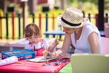 Image showing mom and little daughter drawing a colorful pictures