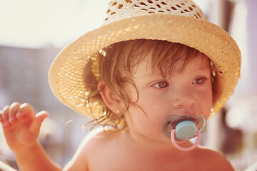 Image showing tired little girl resting on sunbed