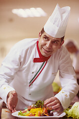 Image showing chef serving vegetable salad