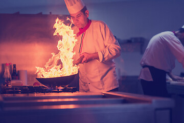 Image showing Chef doing flambe on food