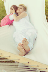 Image showing mother and a little daughter relaxing in a hammock