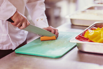 Image showing Chef hands cutting fresh and delicious vegetables