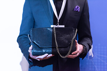 Image showing young businessman holding leather bag