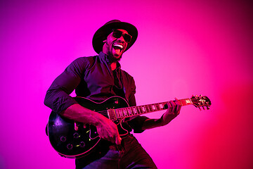 Image showing Young african-american jazz musician playing the guitar