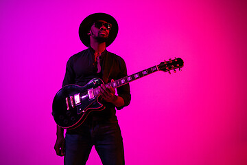 Image showing Young african-american jazz musician playing the guitar