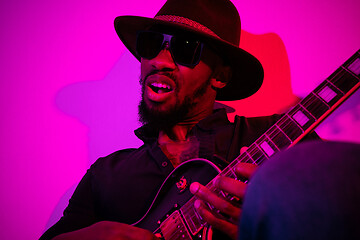 Image showing Young african-american jazz musician playing the guitar