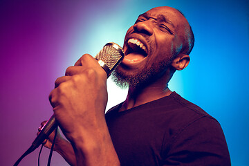 Image showing Young african-american jazz musician singing a song