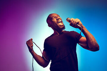 Image showing Young african-american jazz musician singing a song